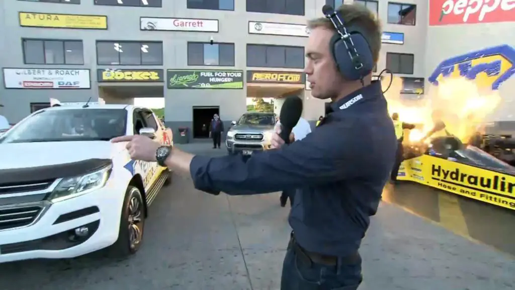 Reporter Chad Neylon doing a live report when the Jim Read Racing crew were engulfed in flames feet away