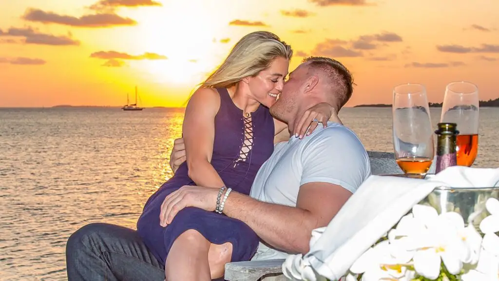 Houston Texans star J.J. Watt kisses his fiancee Kealia Ohai in an intimate photo as the sun comes down