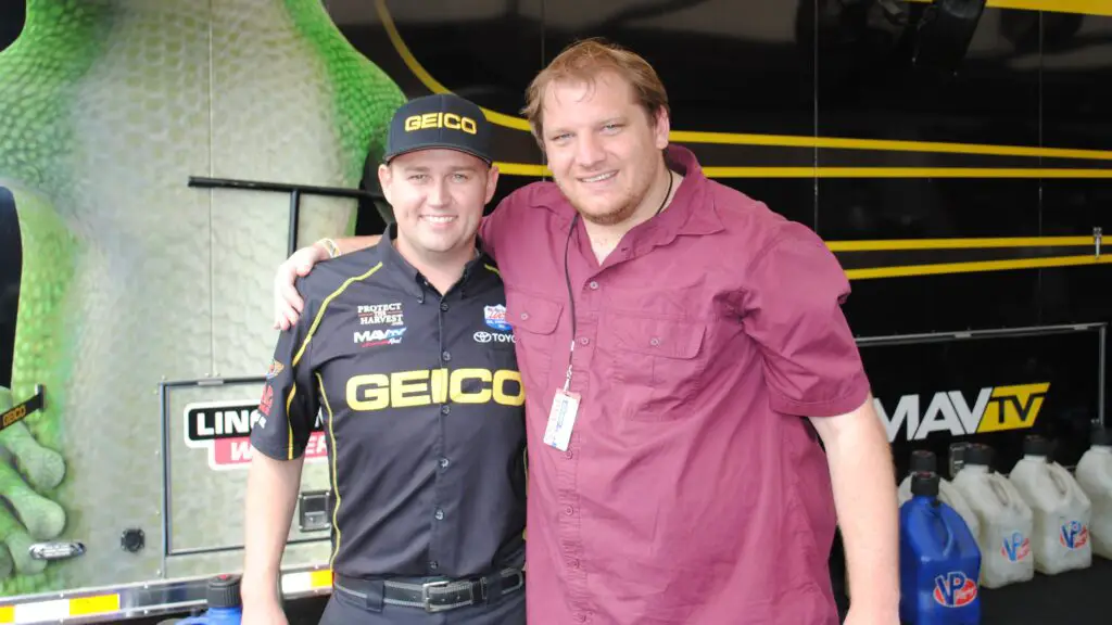 Geico Top Fuel Dragster driver Richie Crampton stands next to our Publisher Anthony Caruso III in the pits at the NHRA national event at Old Bridge Township Raceway Park