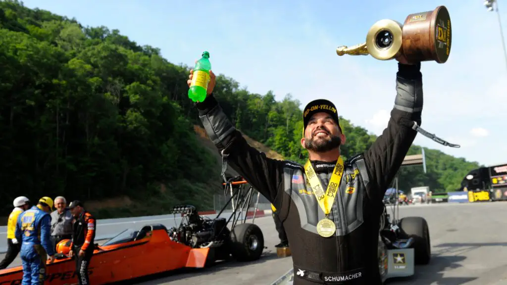 Race car driver Tony Schumacher with the Wally after winning the NHRA Thunder Valley Nationals