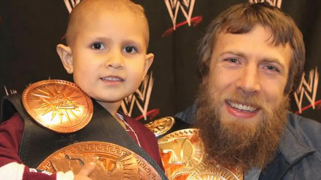 WWE superstar Daniel Bryan shares a moment with sick patient Connor Michalek before a live event