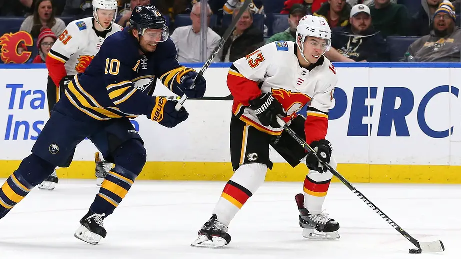 Former Calgary Flames star Johnny Gaudreau skates with the puck as Jacob Josefson of the Buffalo Sabres pursues him during the third period