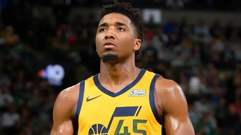 Former Utah Jazz superstar Donovan Mitchell looks on with the ball in his hand during a game
