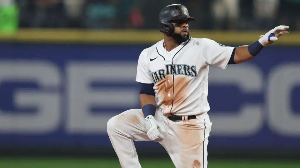 Former Seattle Mariners slugger Carlos Santana gestures after advancing to second base during the seventeenth inning against the Houston Astros in Game 3 of the American League Division Series