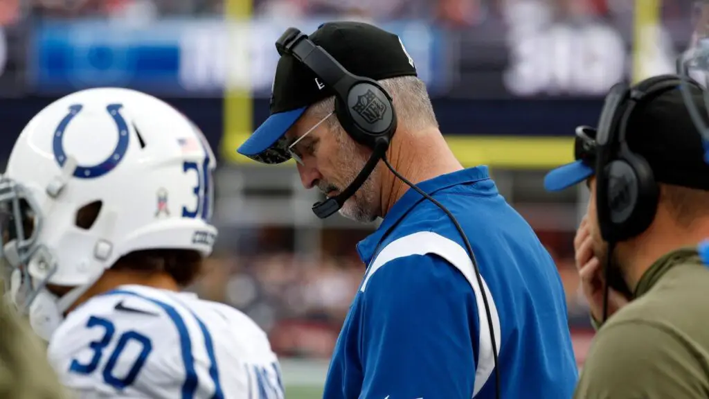 Former Indianapolis Colts head coach Frank Reich checks his notes during a game against the New England Patriots