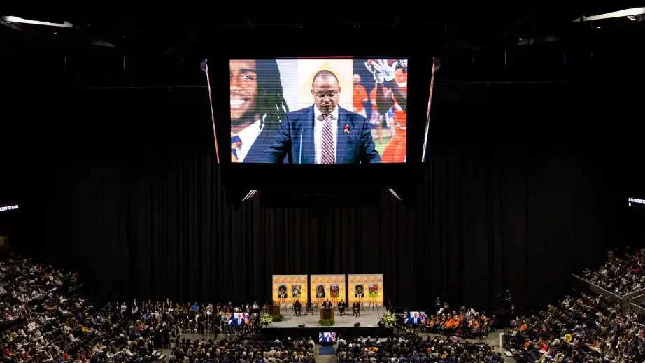 Virginia Cavaliers head coach Tony Elliott speaks during a memorial service for three slain football players at John Paul Jones Arena on campus