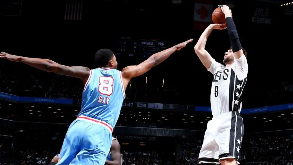 Brooklyn Nets player Andrea Bargnani shoots over Rudy Gay against the Sacramento Kings during their game