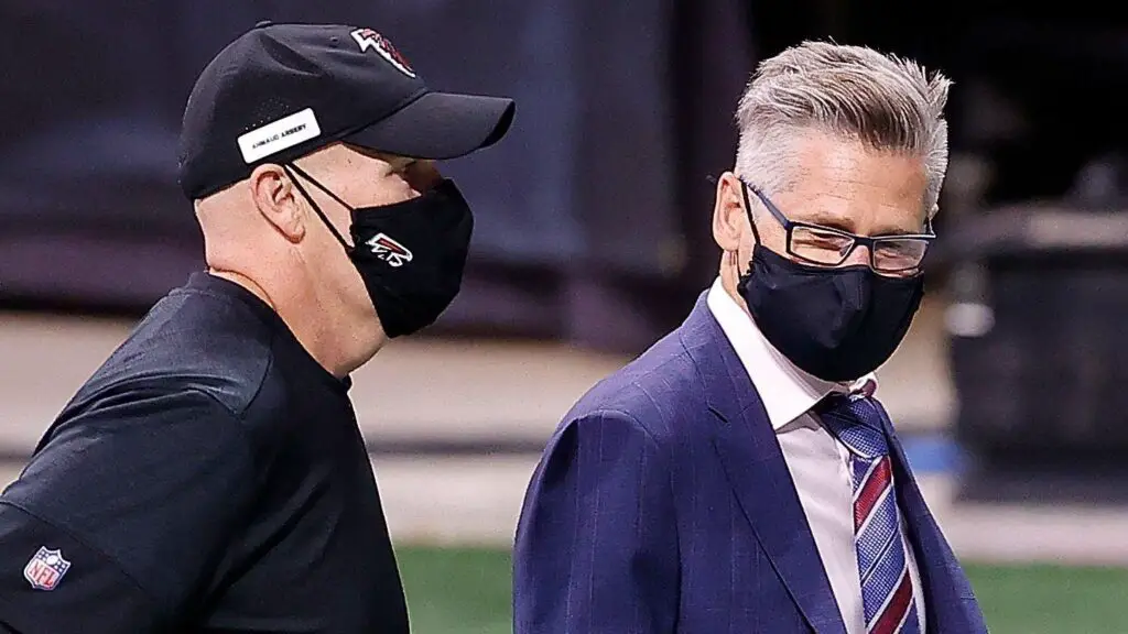 Former Atlanta Falcons head coach Dan Quinn and General Manager Thomas Dimitroff walk off the field after their 23-16 loss to the Carolina Panthers
