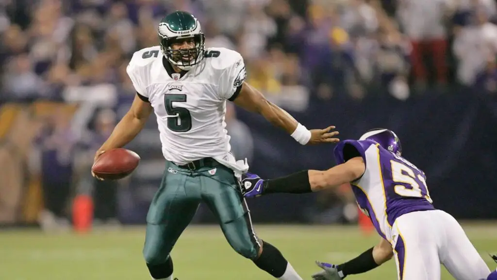 Philadelphia Eagles quarterback Donovan McNabb scrambles away from a Minnesota Vikings defender