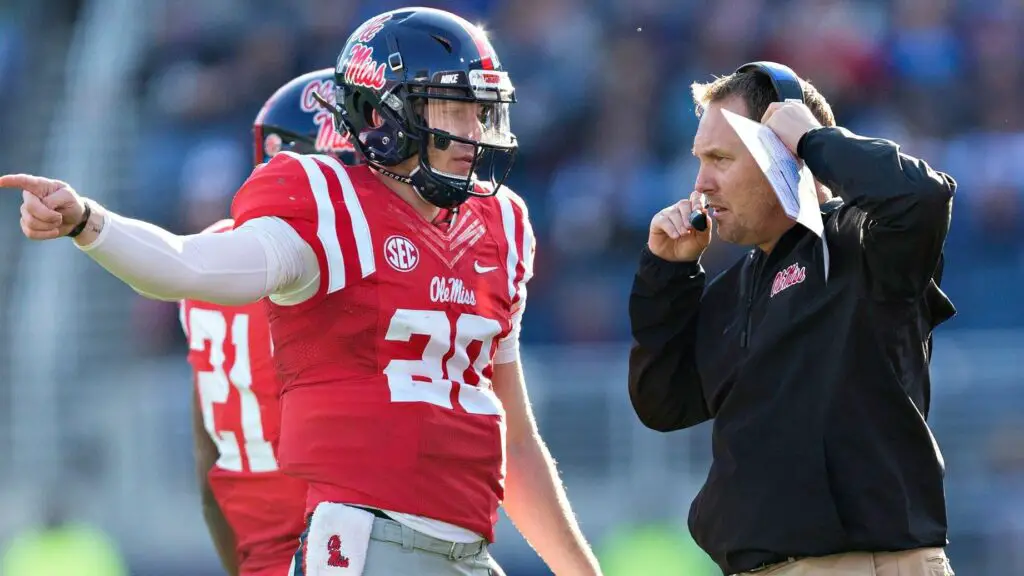 Former Ole Miss Rebels head coach Hugh Freeze talks with Shea Patterson during a game against the Mississippi State Bulldogs