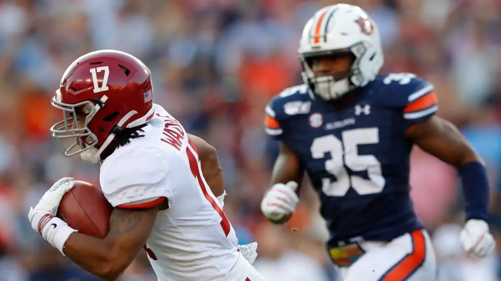 Alabama Crimson Tide wide receiver Jaylen Waddle makes a reception and scores a touchdown against Christian Tutt against the Auburn Tigers in the first half 