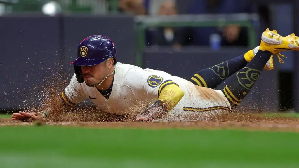 Former Milwaukee Brewers second baseman Kolten Wong beats the tag at home by Cooper Hummel against the Arizona Diamondbacks during the ninth inning