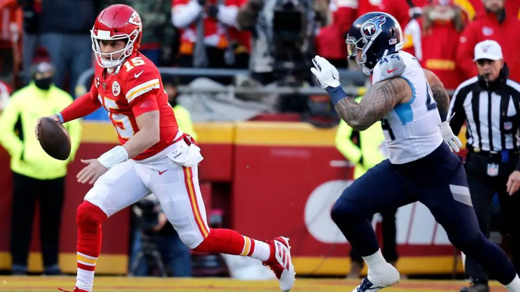 Kansas City Chiefs quarterback Patrick Mahomes II scrambles as Kamalei Correa tries to chase him down against the Tennessee Titans in the first quarter of the AFC Championship Game