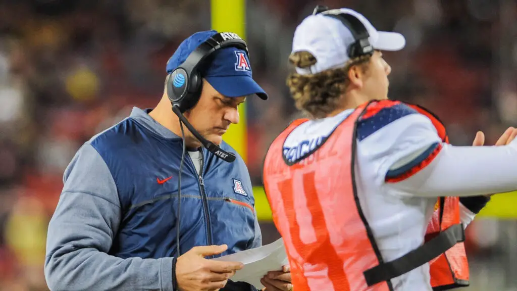 Former Arizona Wildcats head coach Rich Rodriguez looks down at his play sheet during the Foster Farms Bowl between the Wildcats and the Purdue Boilermakers