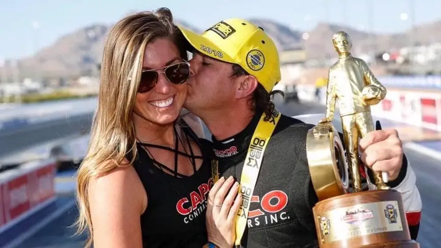 Capco Contractors Top Fuel Dragster driver Steve Torrence kisses Natalie Jahnke after an NHRA win at an NHRA national event