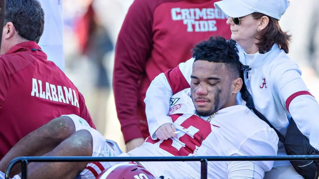 Alabama Crimson Tide quarterback Tua Tagovailoa is helped off the field after being injured on a play in the first half of a game against the Mississippi State Bulldogs