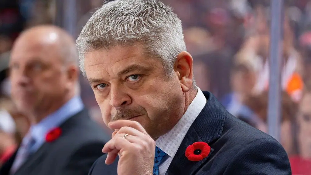 Former Edmonton Oilers head coach Todd McLellan watches the action from the bench against the Detroit Red Wings during an NHL game