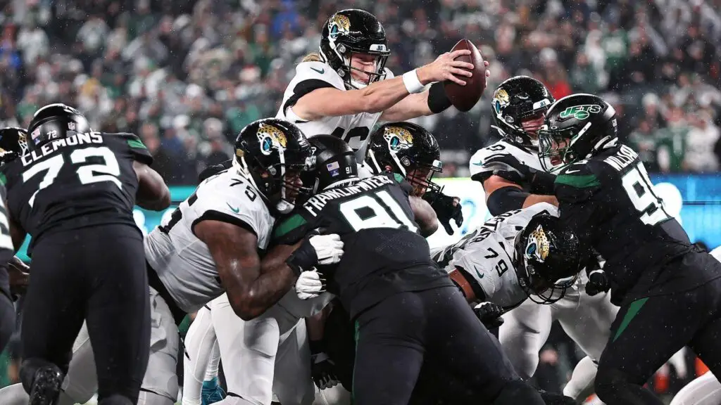 Jacksonville Jaguars quarterback Trevor Lawrence dives over the goal line for a touchdown during the first half against the New York Jets
