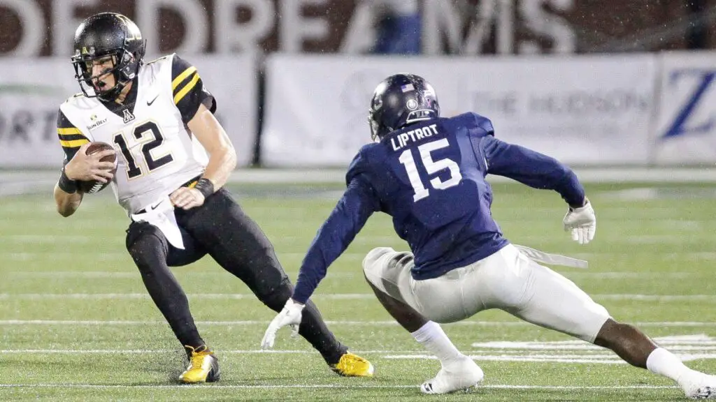 Appalachian State Mountaineers quarterback Zac Thomas looks for running room as Georgia Southern Eagles player Jessie Liptrot attempts to tackle him during the first quarter 