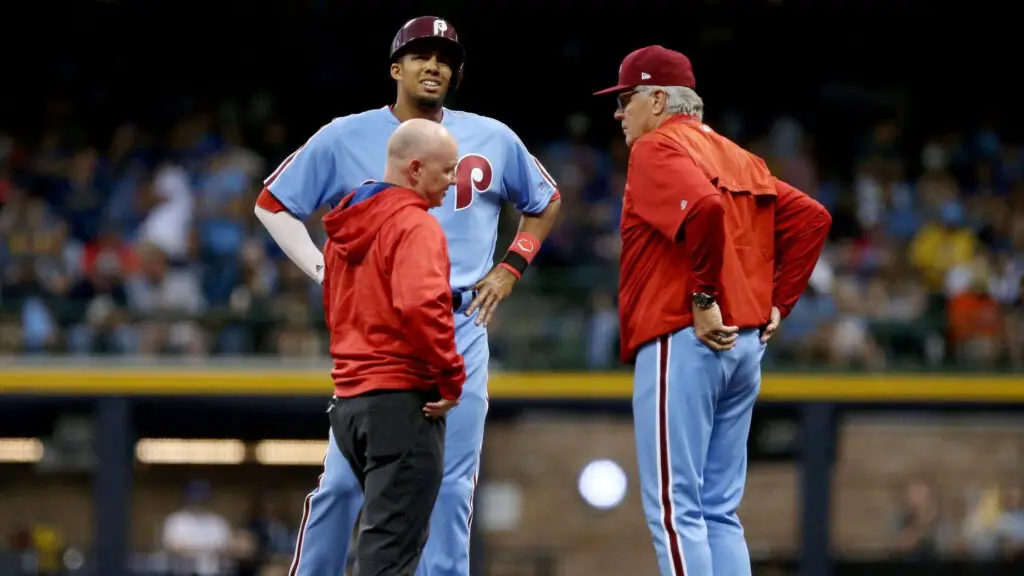 Philadelphia Phillies outfielder Aaron Altherr is examined after being injured in the fifth inning against the Milwaukee Brewers