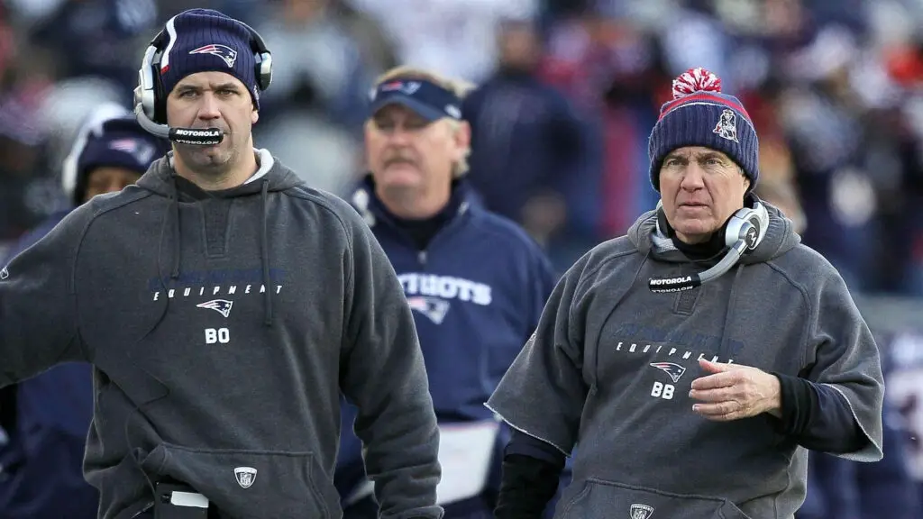 New England Patriots head coach Bill Belichick and offensive coordinator Bill O’Brien look on against the Baltimore Ravens during the 2010 AFC Wild Card Game