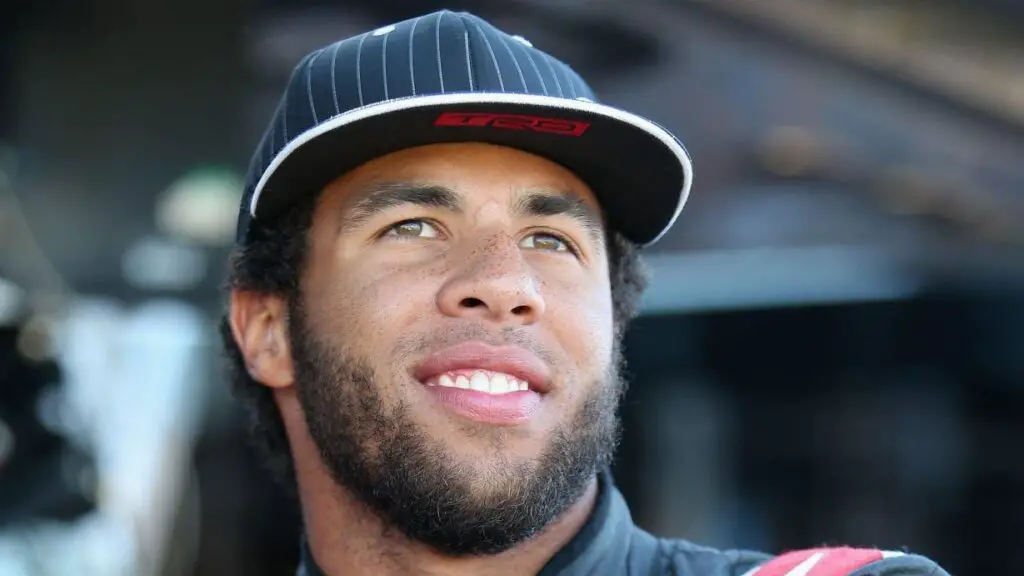 NASCAR driver Darrell Wallace Jr. stands in the garage area during practice for the NASCAR Camping World Truck Series Lucas Oil 150 at Phoenix International Raceway