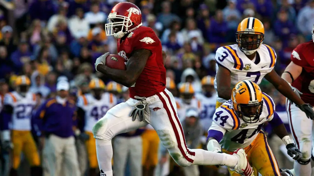 Arkansas Razorbacks running back Darren McFadden runs with the football past Danny McCrary against the LSU Tigers to score a touchdown