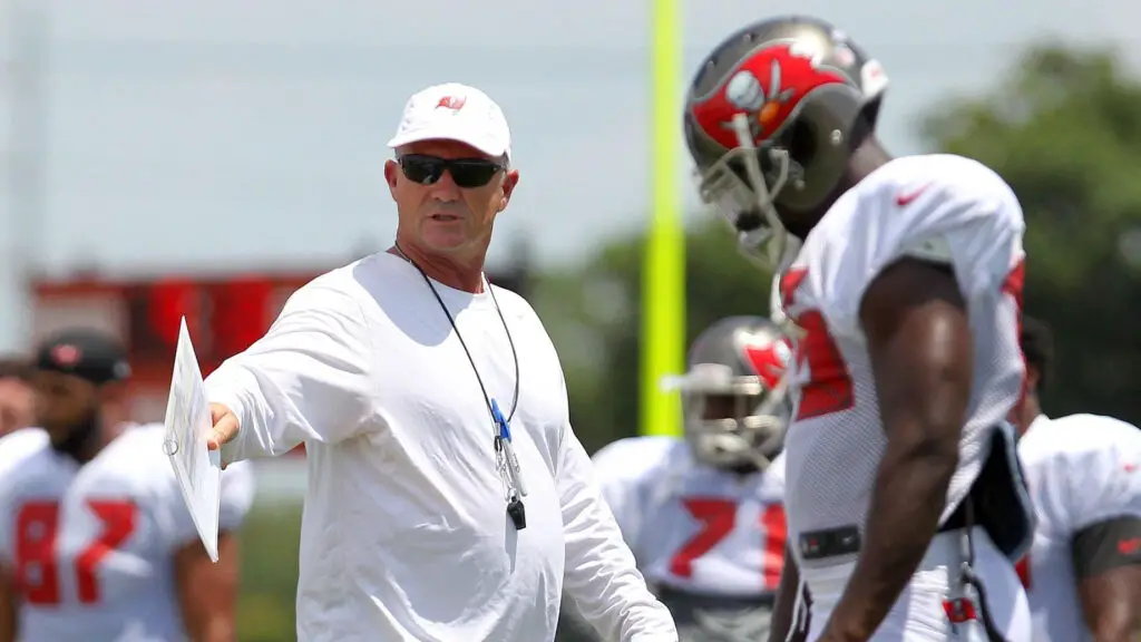 Former Tampa Bay Buccaneers offensive coordinator Jeff Tedford talks to a player during the Buccaneers Training Camp