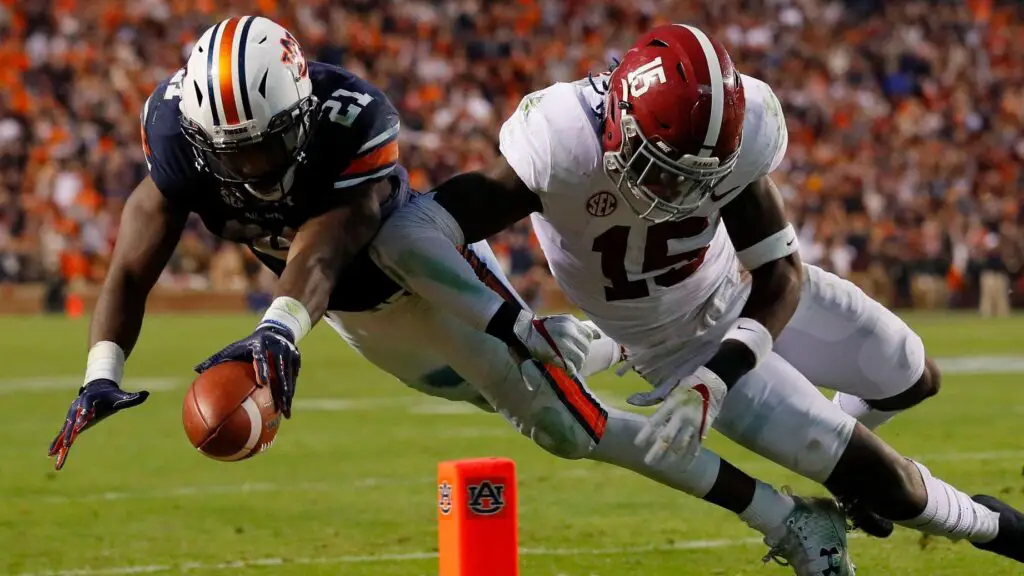 Auburn Tigers running back Kerryon Johnson is hit by Ronnie Harrison against the Alabama Crimson Tide as he drives towards the end zone during the third quarter of their game