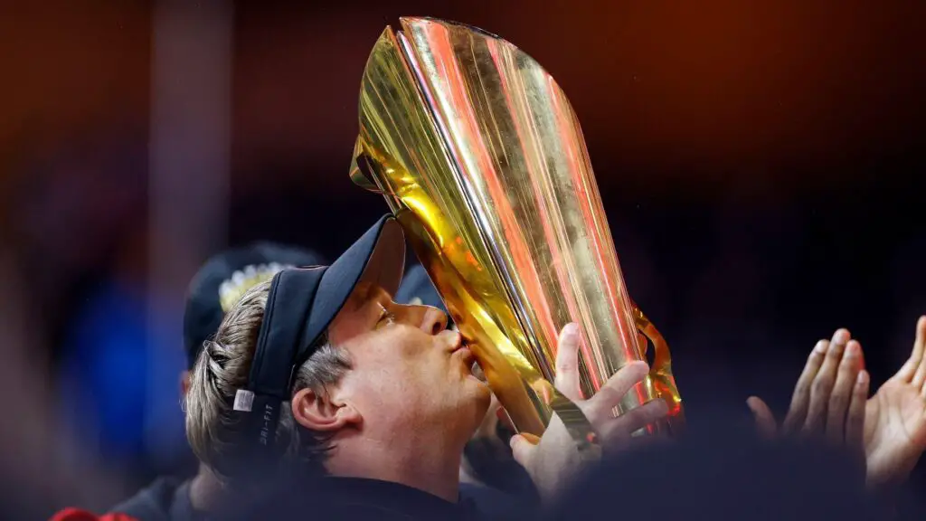 Georgia Bulldogs head coach Kirby Smart raises the College Football Playoff National Championship Trophy after defeating the TCU Horned Frogs in the College Football Playoff National Championship game 