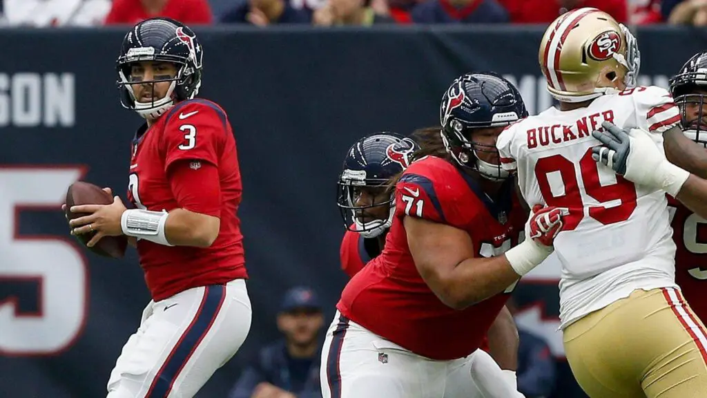 Former Houston Texans quarterback Tom Savage looks for a receiver as Xavier Su'a-Filo blocks DeForest Buckner against the San Francisco 49ers
