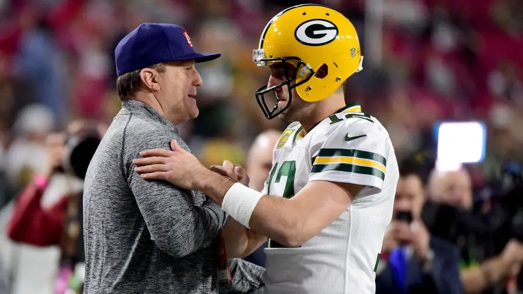 Former ESPN employee Curt Schilling talks with Green Bay Packers quarterback Aaron Rodgers before the NFC Divisional Playoff Game