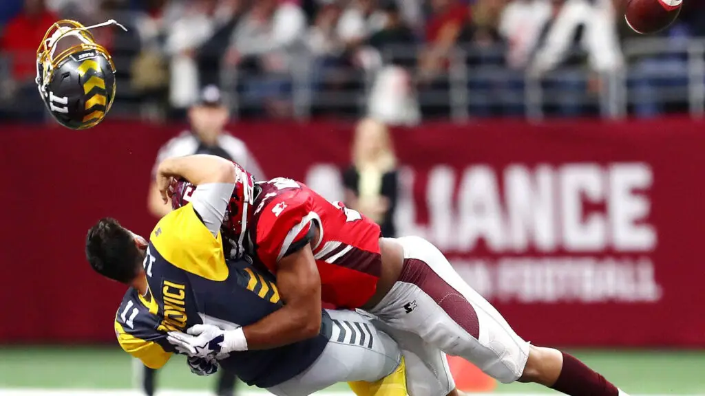 San Diego Fleet quarterback Mike Bercovici loses his helmet as he is tackled by Shaan Washington against the San Antonio Commanders during the first quarter in an Alliance of American Football Game 