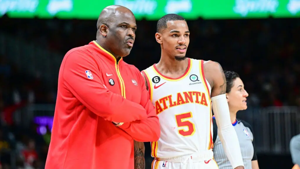 Former Atlanta Hawks head coach Nate McMillan and star Dejounte Murray look on during a break in the action against the Phoenix Suns