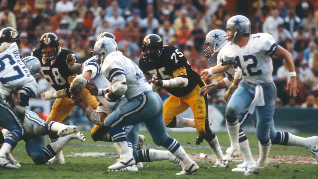 Dallas Cowboys running back Robert Newhouse carries the ball while pursued by Joe Greene against the Pittsburgh Steelers during Super Bowl XIII 