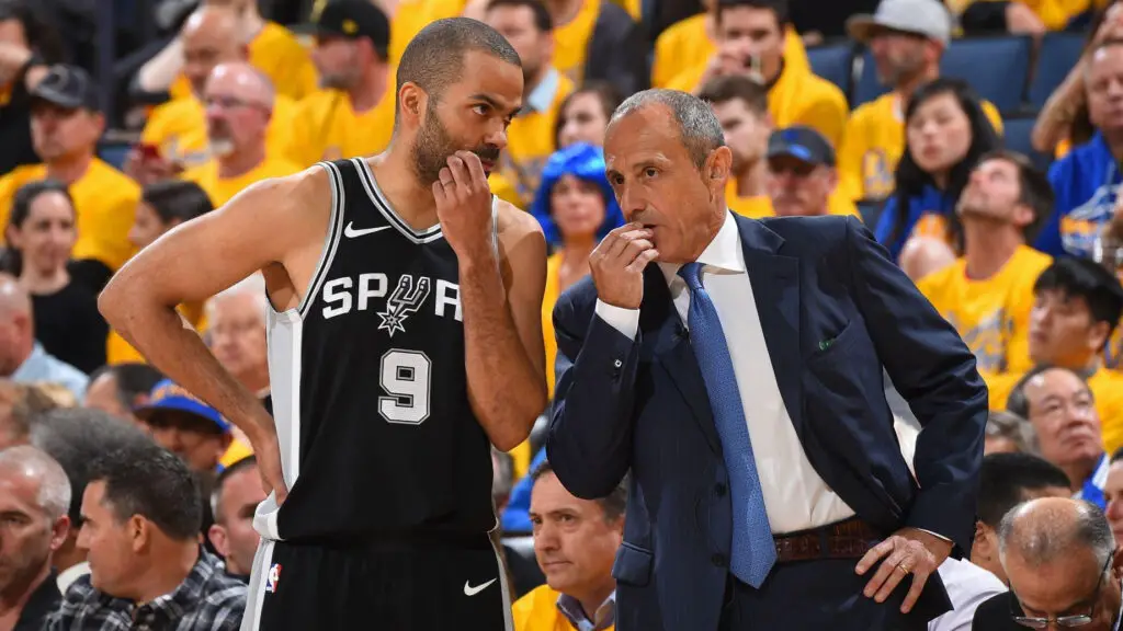 San Antonio Spurs star Tony Parker speaks with assistant coach Ettore Messina during a break in the action again during the game against the Golden State Warriors in Game Five of Round One of the 2018 NBA Playoffs