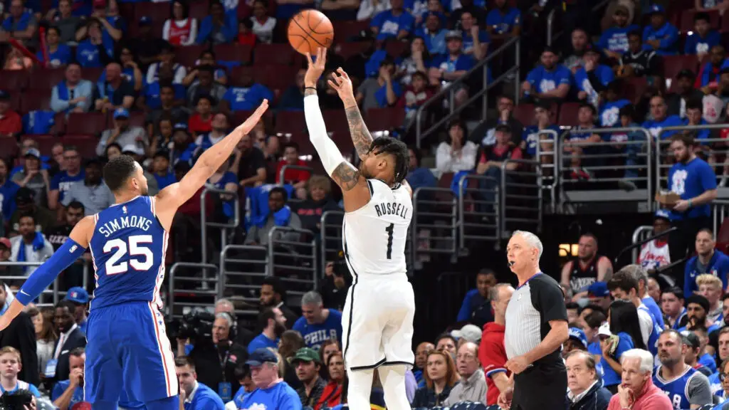 Brooklyn Nets star D'Angelo Russell shoots a three-pointer against Ben Simmons #25 of the Philadelphia 76ers during Game One of Round One of the 2019 NBA Playoffs