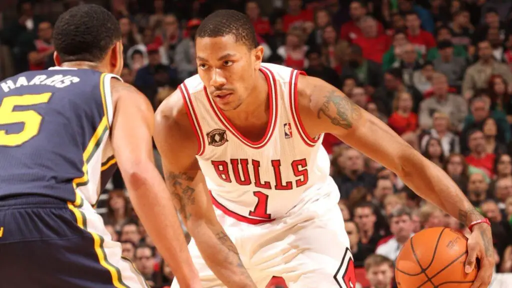 Chicago Bulls star Derrick Rose looks to drive by Devin Harris against the Utah Jazz