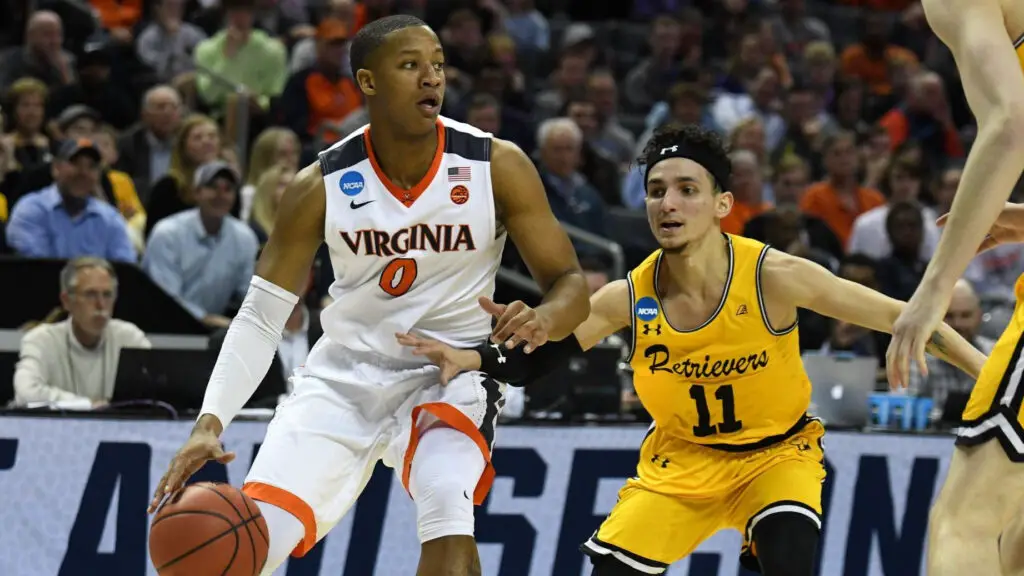 Virginia Cavaliers guard Devon Hall dribbles the ball as he is being defended during the NCAA Division I Men's Championship First Round game between the UMBC Retrievers and the Virginia Cavaliers