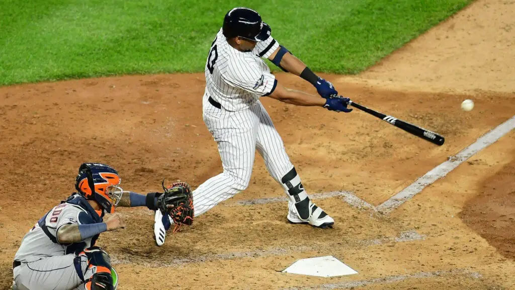 Former New York Yankees player Edwin Encarnacion hits a double during the fifth inning against the Houston Astros in game three of the American League Championship Series