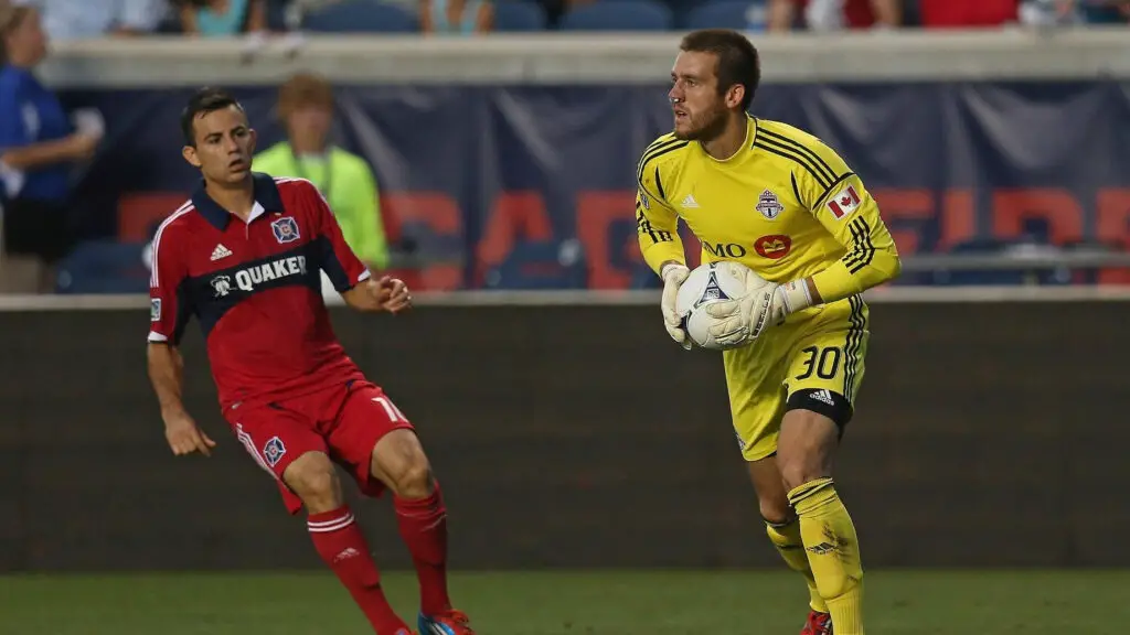Former Toronto FC goaltender Milos Kocic makes a save in front of Marco Pappa against the Chicago Fire during an MLS match