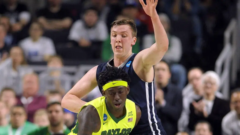 Baylor Bears player Johnathan Motley moves the ball as he is defended by Sam Downey against the Yale Bulldogs during the first round of the 2016 NCAA Men's Basketball Tournament