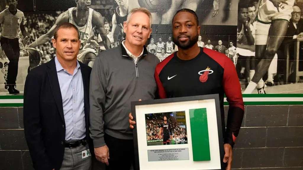Boston Celtics President Rich Gotham and General Manager Danny Ainge present a commemorative plaque to Miami Heat legend Dwyane Wade prior to a game