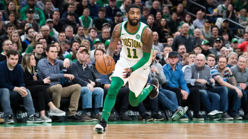 Boston Celtics point guard Kyrie Irving brings the ball up the court during a game