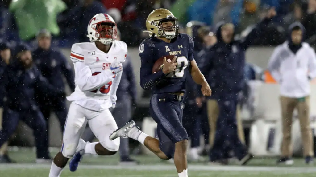 Navy Midshipmen quarterback Malcolm Perry outruns defensive back Brandon Stephens against the Southern Methodist Mustangs for a fourth-quarter touchdown