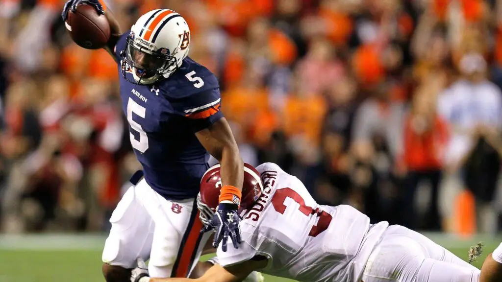 Former Auburn Tigers running back Michael Dyer is tackled by Vinnie Sunseri of the Alabama Crimson Tide