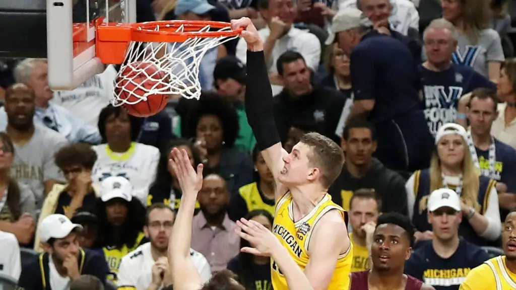 Michigan Wolverines center Moritz Wagner dunks in the second half as Cameron Krutwig looks on against the Loyola Ramblers during the 2018 NCAA Men's Final Four Semifinal
