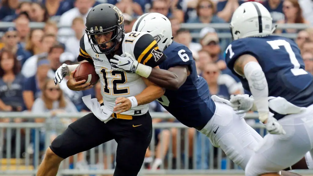 Appalachian State Mountaineers quarterback Zac Thomas is sacked by Cam Brown against the Penn State Nittany Lions