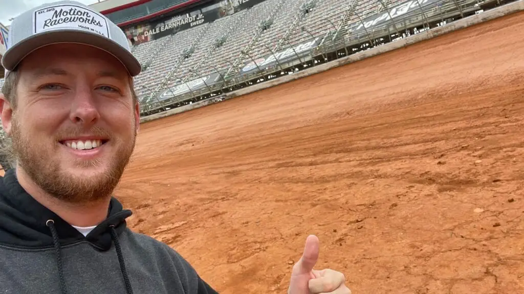 YouTube content creator Cleetus McFarland gives a thumbs up near a dirt track