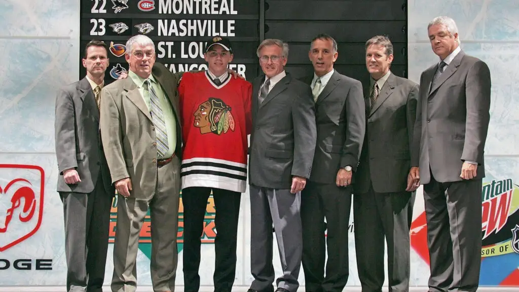 2007 NHL Entry Draft First Overall pick Patrick Kane poses for a photo with members of the Chicago Blackhawks staff on the draft stage during the first round of the 2007 NHL Entry Draft